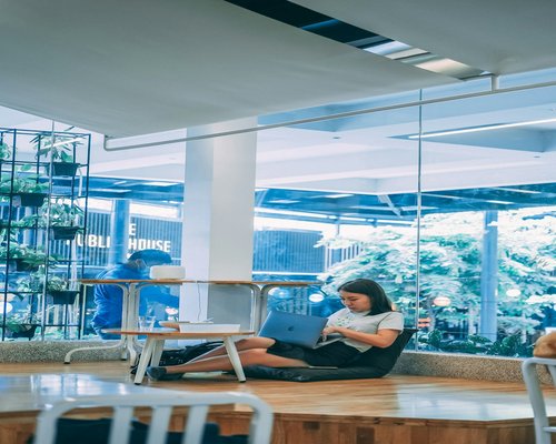 Office worker in Kuala Lumpur managing screen time and hydration at a bright desk